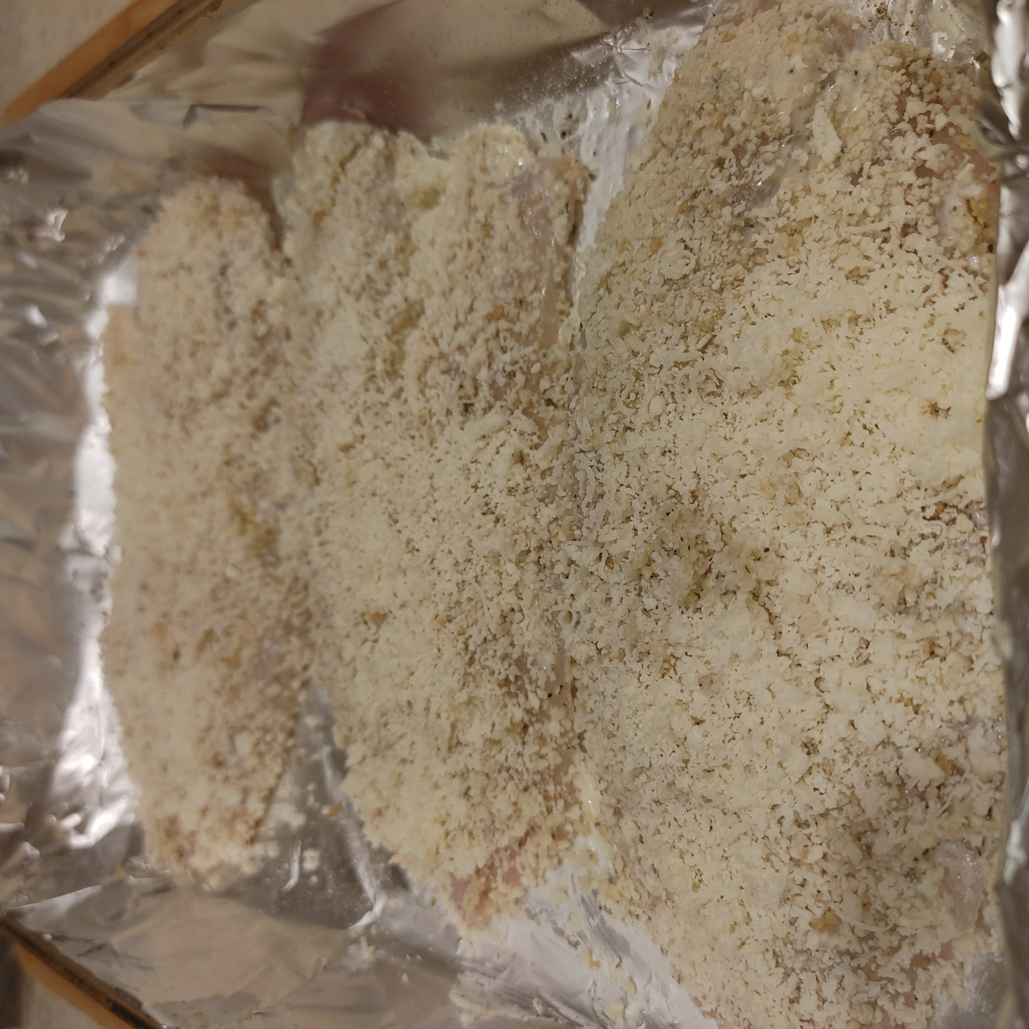 PRESS THE PARMESAN CRUST INTO THE FISH FILLETS