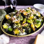 LARGE PLATTER FILLED WITH ROASTED BRUSSELS SPOUTS GLAZED WITH BALSAMIC VINEGAR
