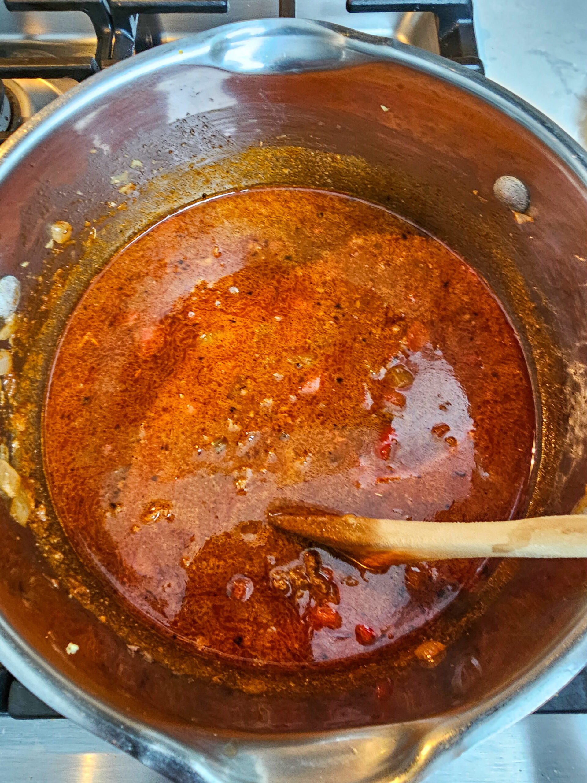 ADD THE BEEF BROTH AND TOMATO SAUCE