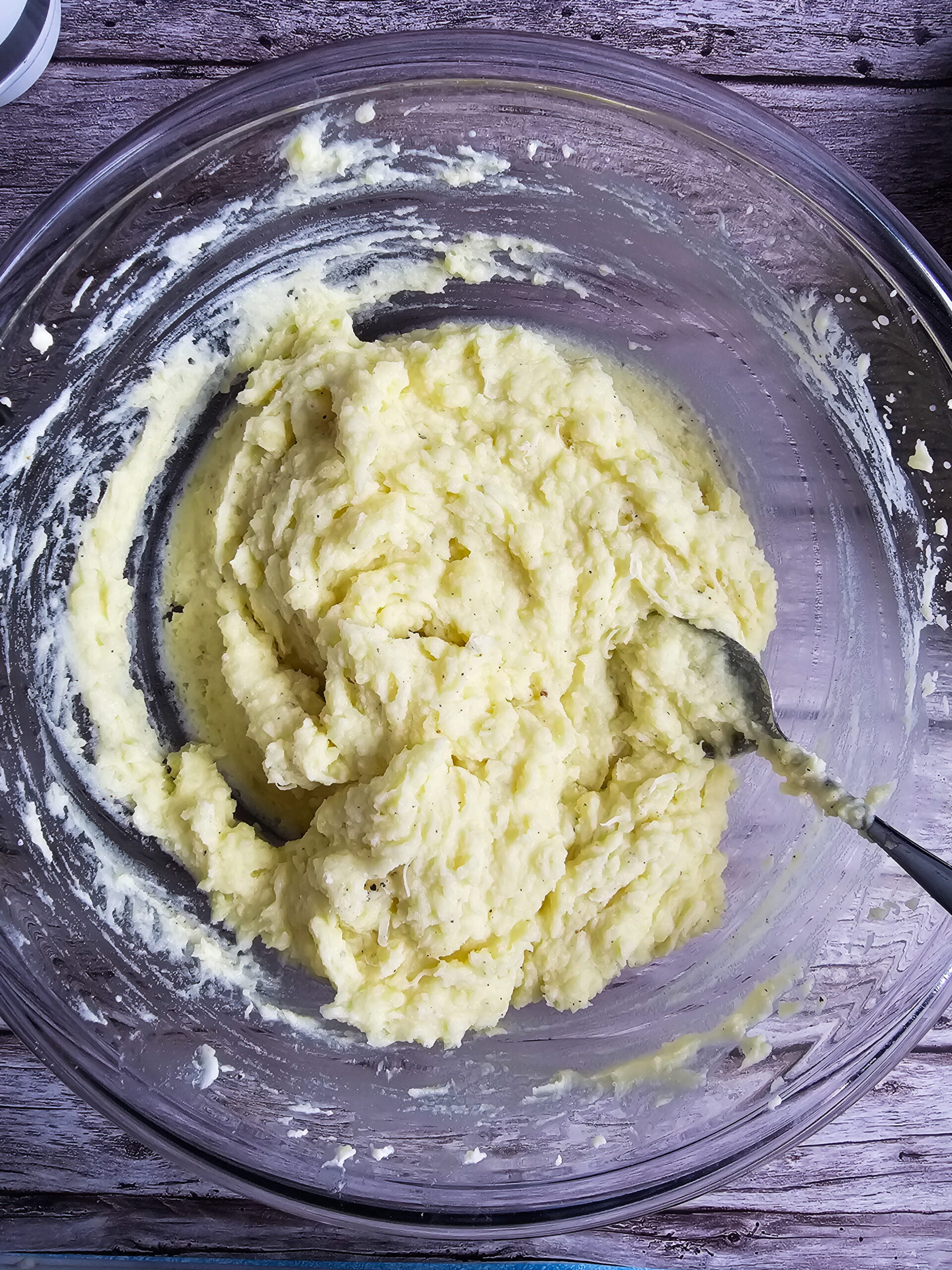 Riced potatoes combined with butter and milk in a large mixing bowl for Chantilly mashed potatoes
