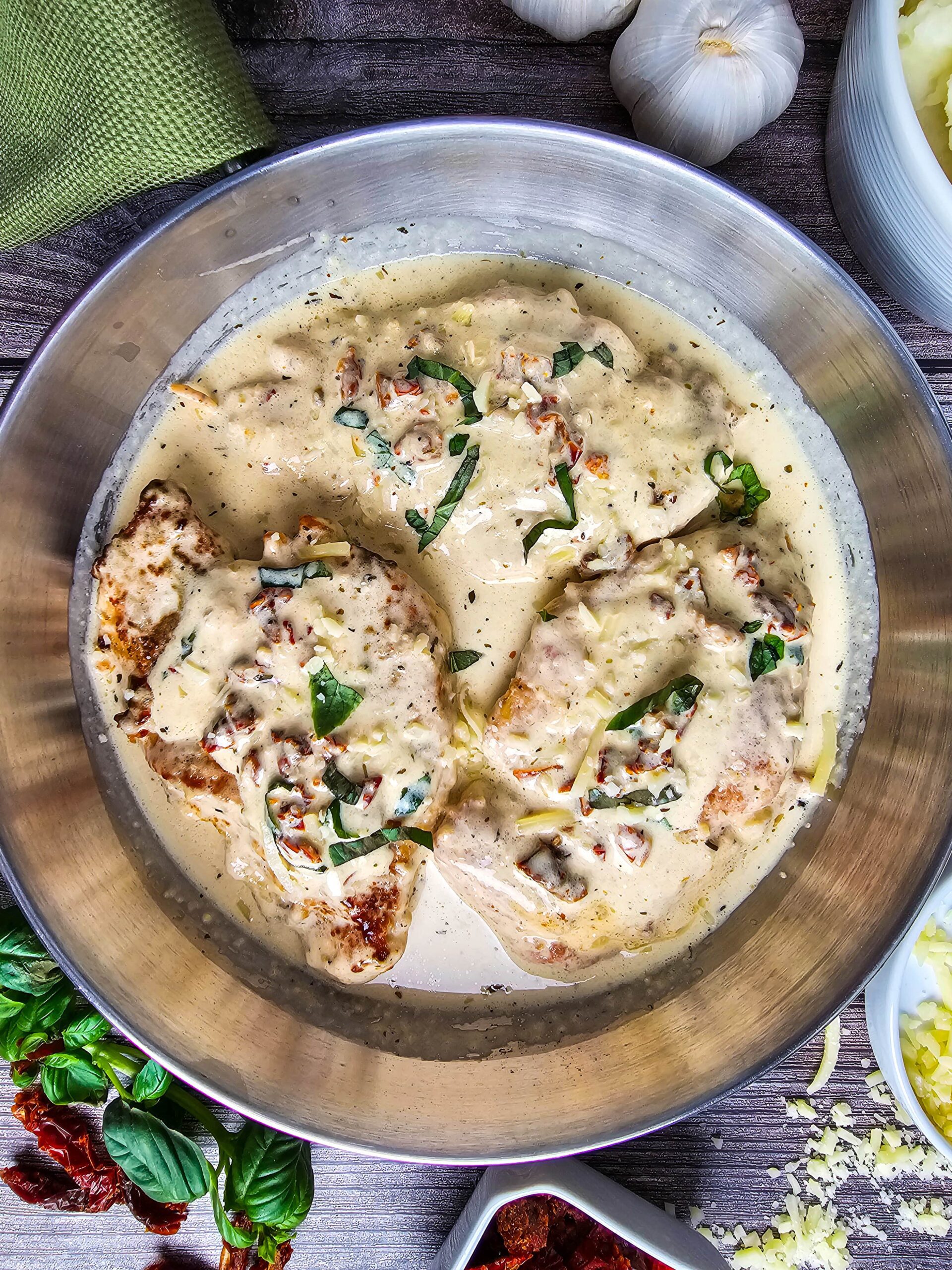 THREE CHICKEN BREASTS SWIMMING IN CREAMY MARRY ME SAUCE GARNSHED WITH SUN DRIED TOMATO AND BASIL