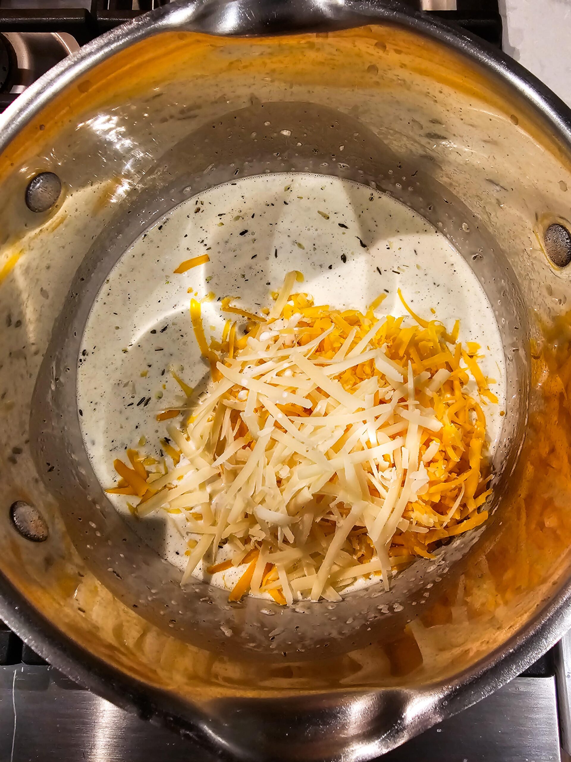 ADD THE SPICES AND CHEESES TO THE AROMATICS