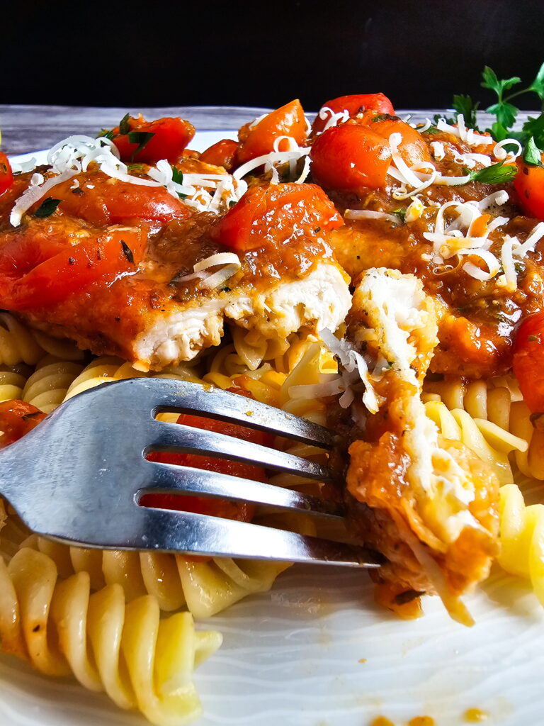 Leftover Italian chicken cutlets with tomato sauce stored in an airtight container in the refrigerator