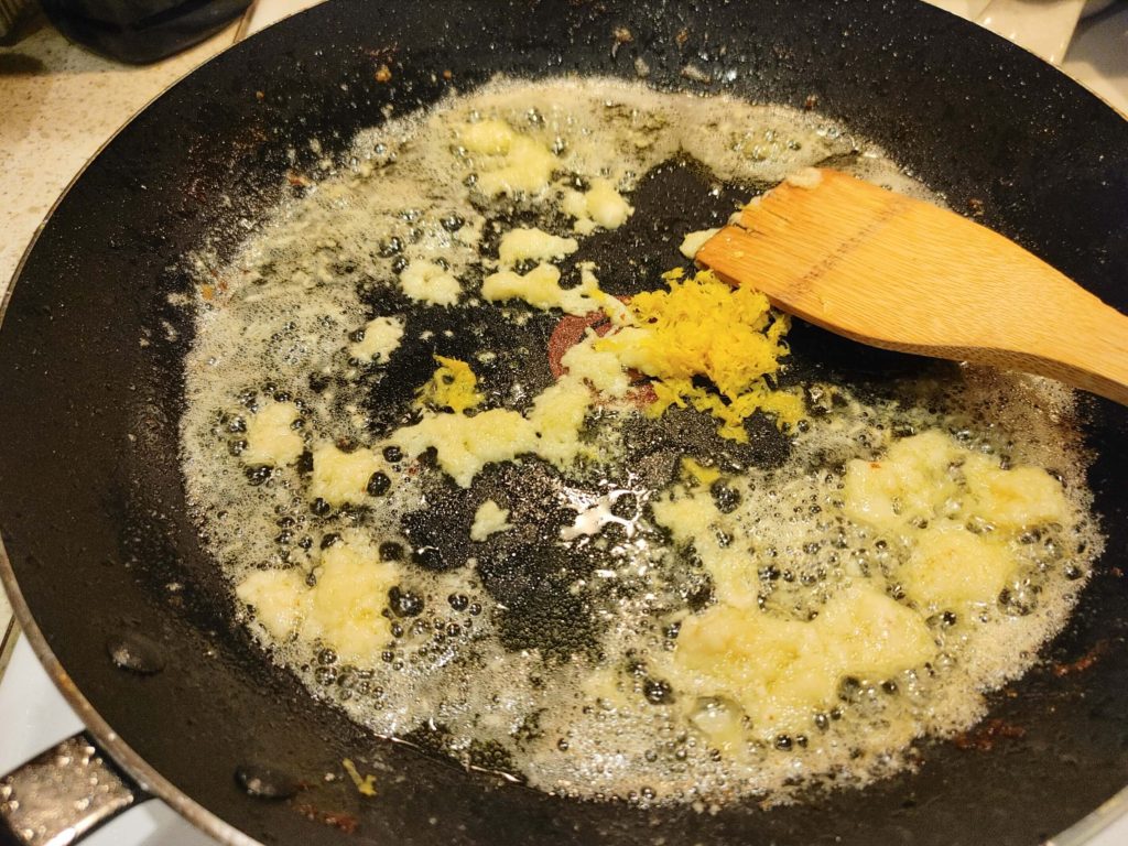 adding butter, olive oil and garlic to the pan