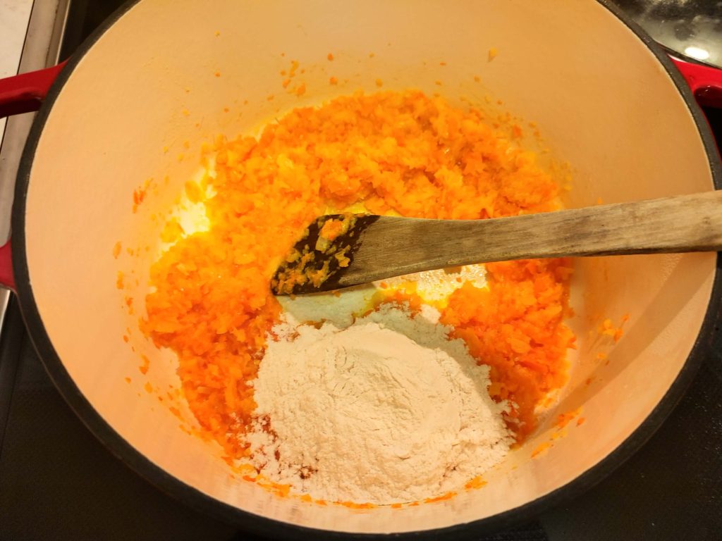 ADD FLOUR TO THE CARROTS AND ONIONS