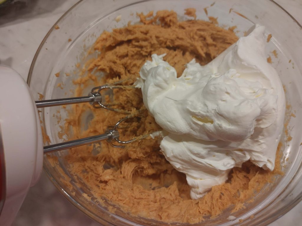 FOLD THE WHIP CREAM INTO THE CREAM CHEESE PEANUT BUTTER MIXTURE