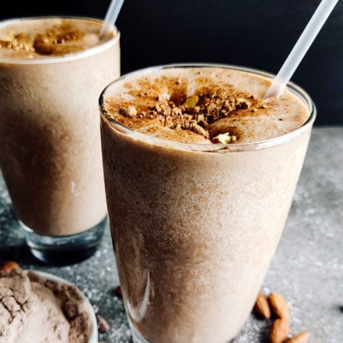 TWO TALL GLASSES OF COFFEE SMOOTHIE WITH A STRAW