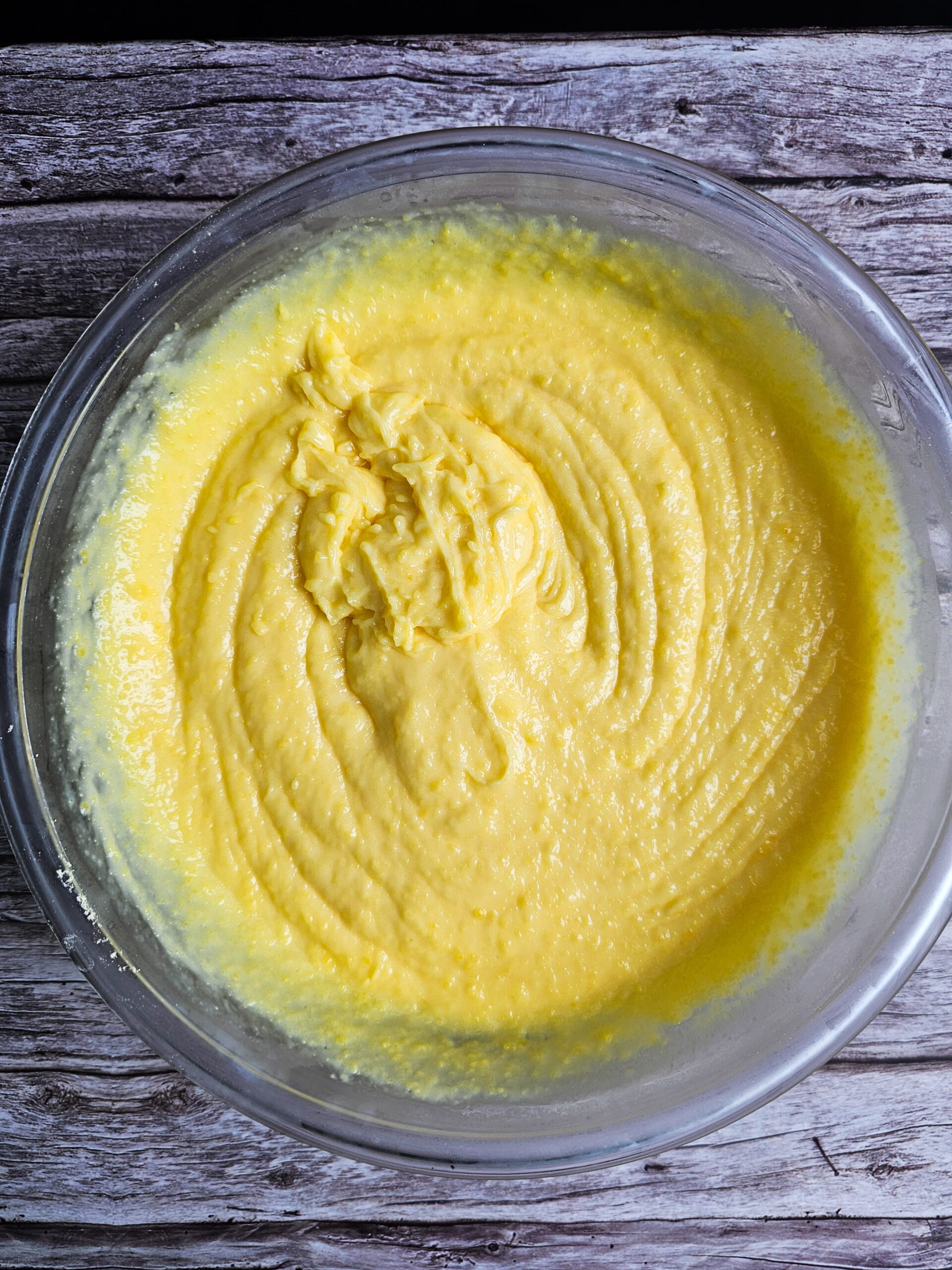Vanilla pudding mix whisked with whole milk in a large bowl for eclair cake filling