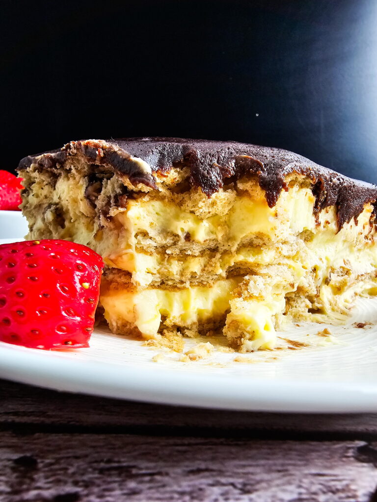 Triple-layer chocolate eclair cake for a crowd made in a 14x11 lasagna pan with homemade fudge topping
