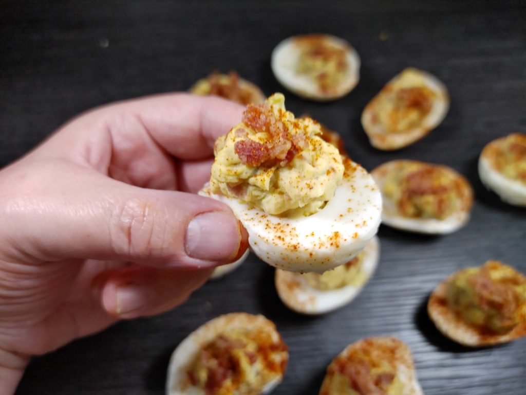 HOLDING A DEVILED EGG IN YOUR HAND
