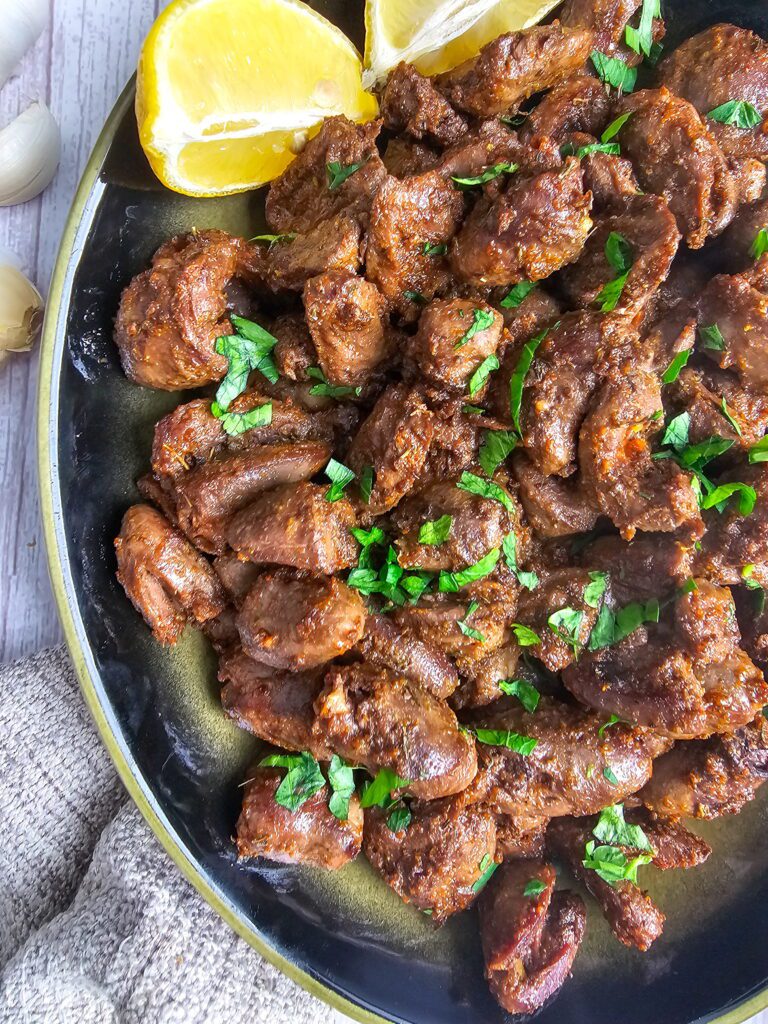 plated sauteed chicken hearts served with side dishes ready for dinner