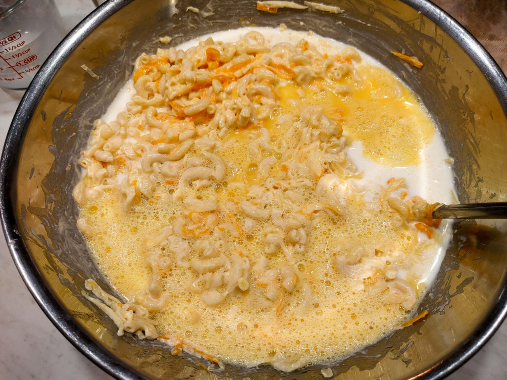 mixing macaroni and cheese ingredients together