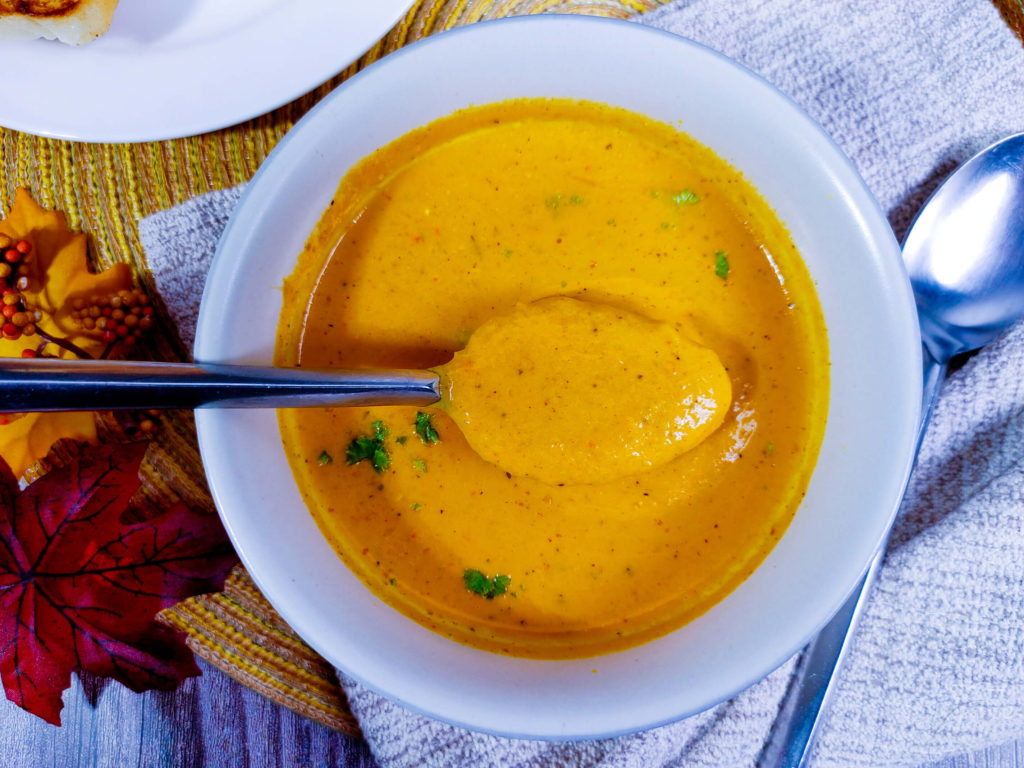 CLOSE UP PICTURE OF RED PEPPER SMOKED GOUDA PUMPKIN SOUP