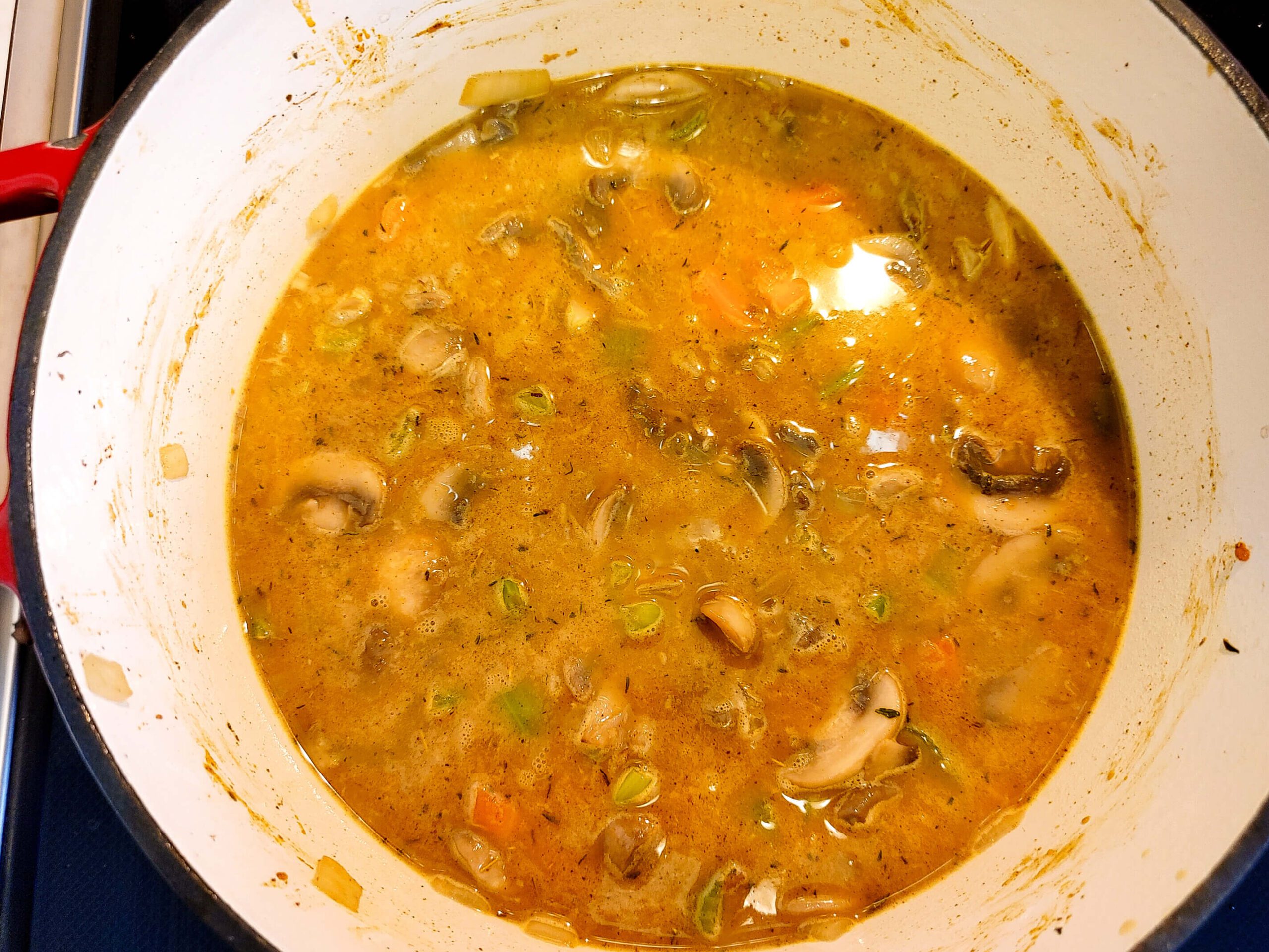 ADD WILD RICE AND CHICKEN BROTH AND SIMMER UNTIL THE RICE IS TENDER