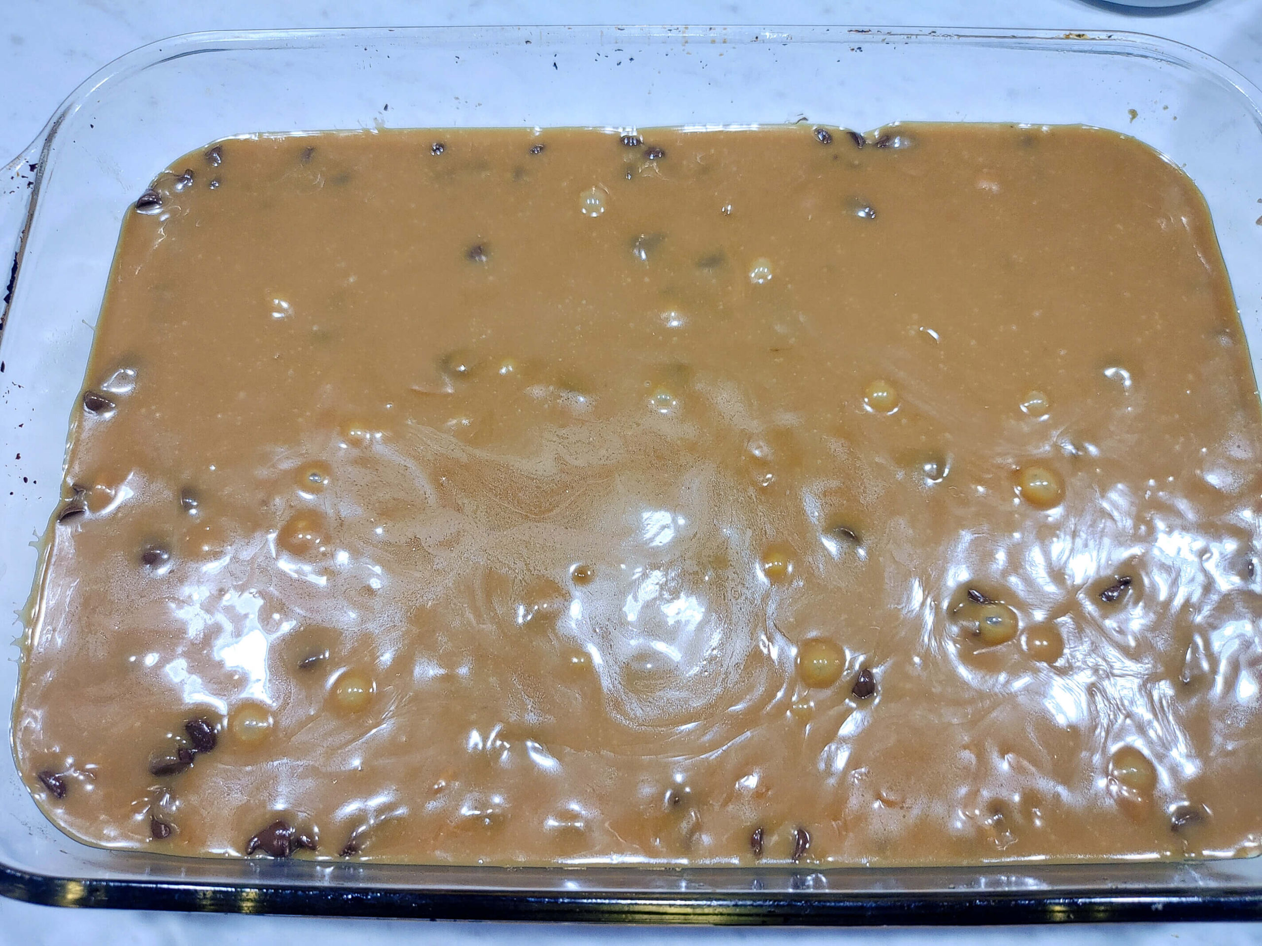 POUR CARAMEL SAUCE OVER CHOCOLATE CHIPS