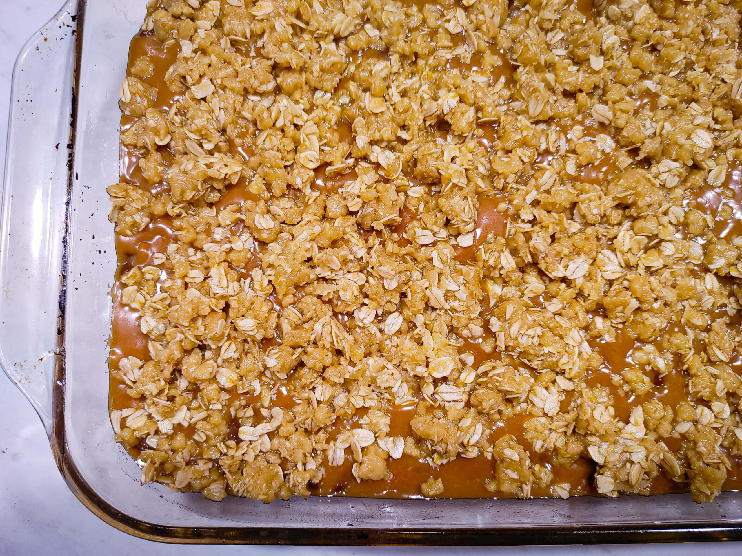 CRUMBLE THE LEFTOVER CRUST OVER THE CARAMEL CHOCOLATE