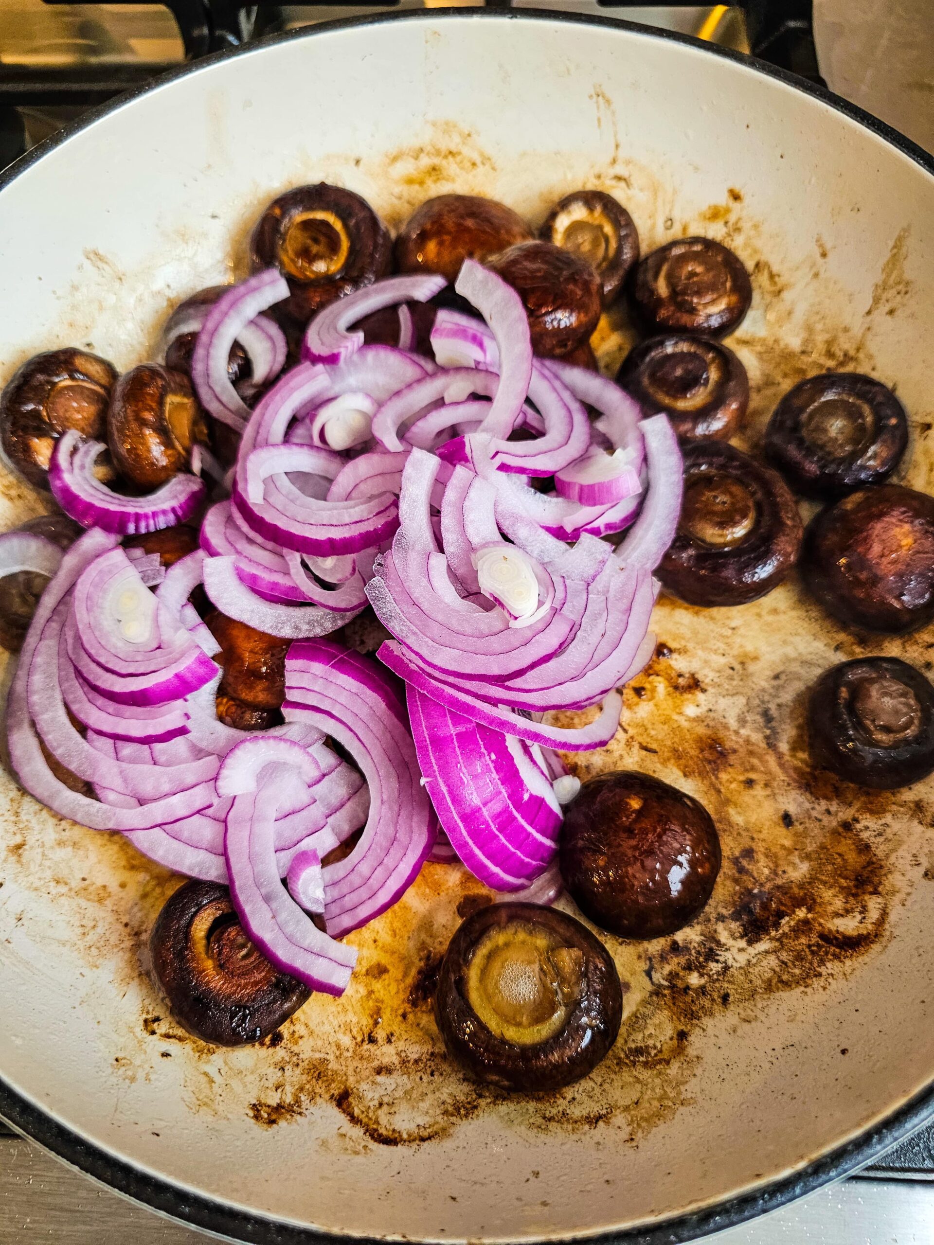 ADD THE RED ONION TO THE SKILLET AND SAUTE
