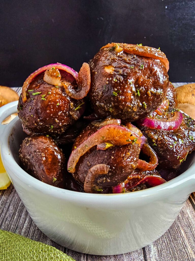 SMALL WHITE BOWL OVERFLOWING WITH SAUTED MUSHROOMS