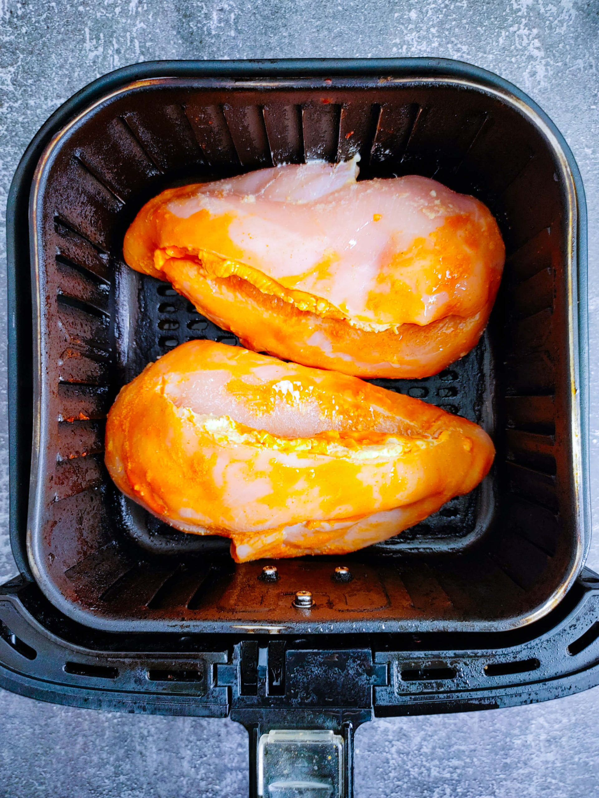 PLACE THE BREASTS IN AIR FRYER