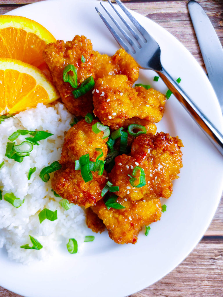 PLATED AIR FRYER ORNAGE CHICKEN SERVED WITH WHITE RICE