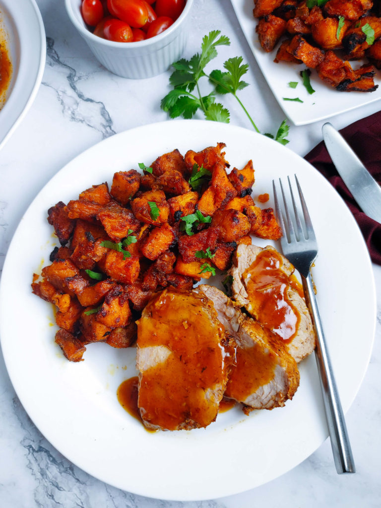 CROCK POT PORK LOIN ROAST PLATED WITH OVEN ROASTED SWEET POTATOES