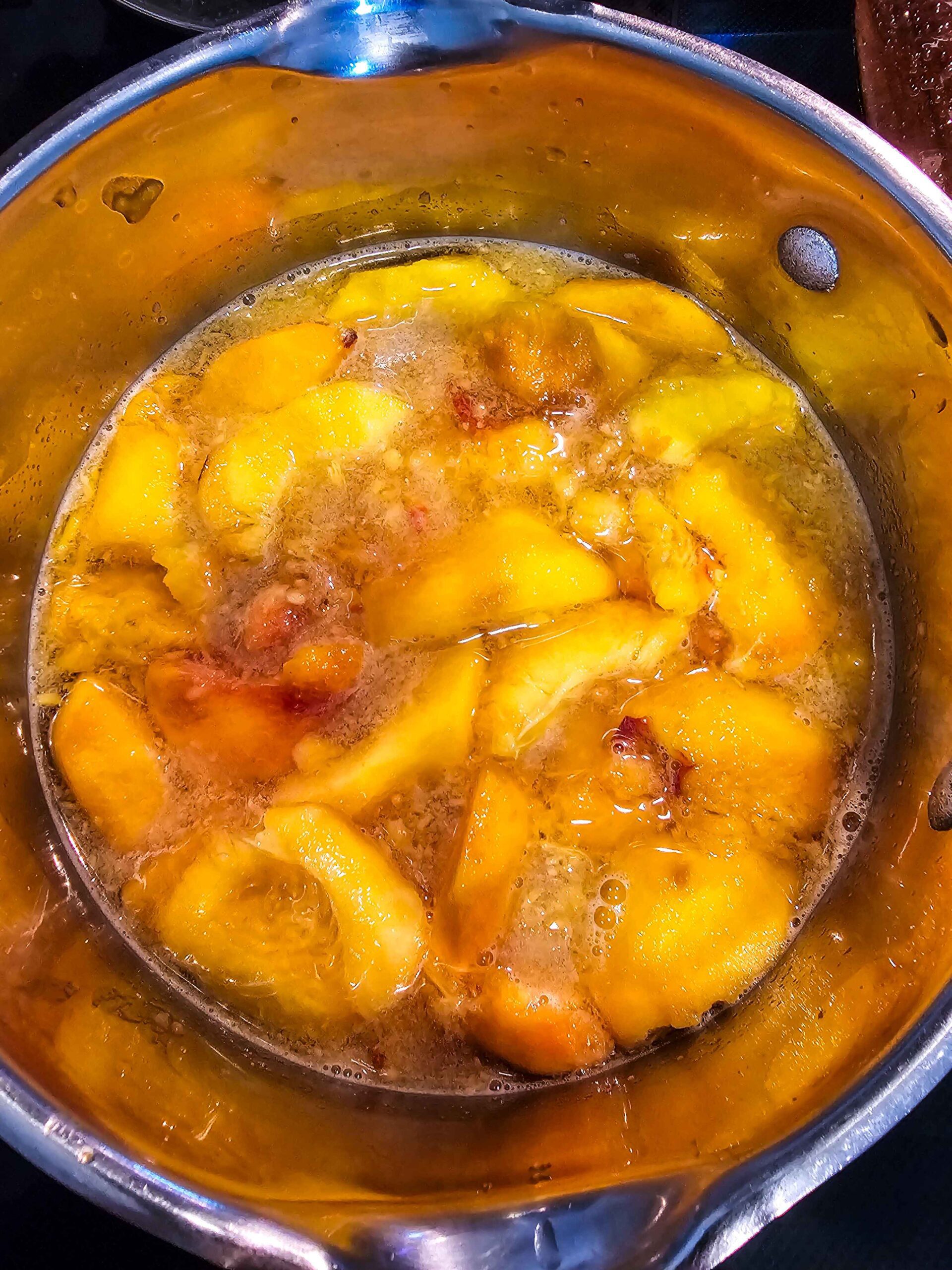 ADD PEACHES, WATER, AND SUGAR TO A SAUCEPAN