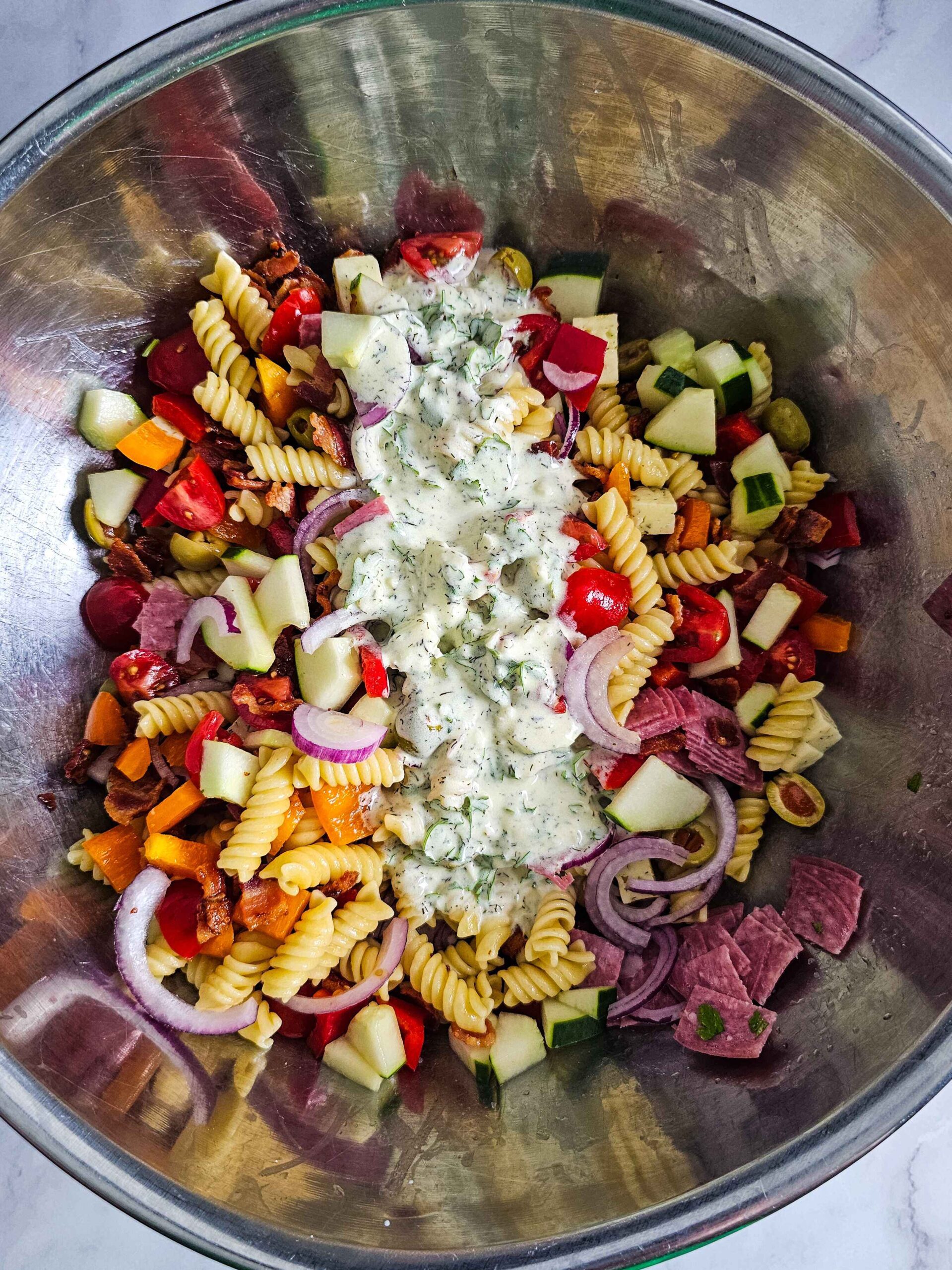 ADD DRESSING TO THE PASTA SALAD INGREDIENTS