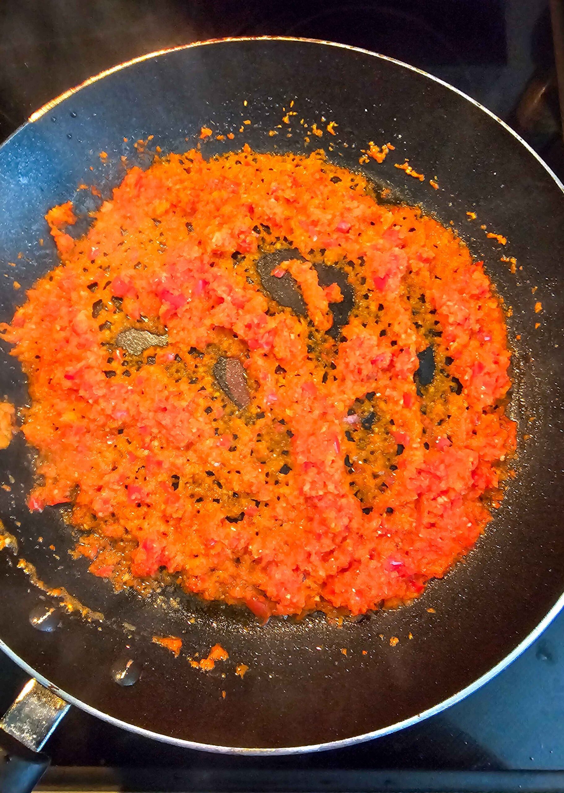 SAUTE THE ONIONS, RED PEPPERS, AND GARLIC