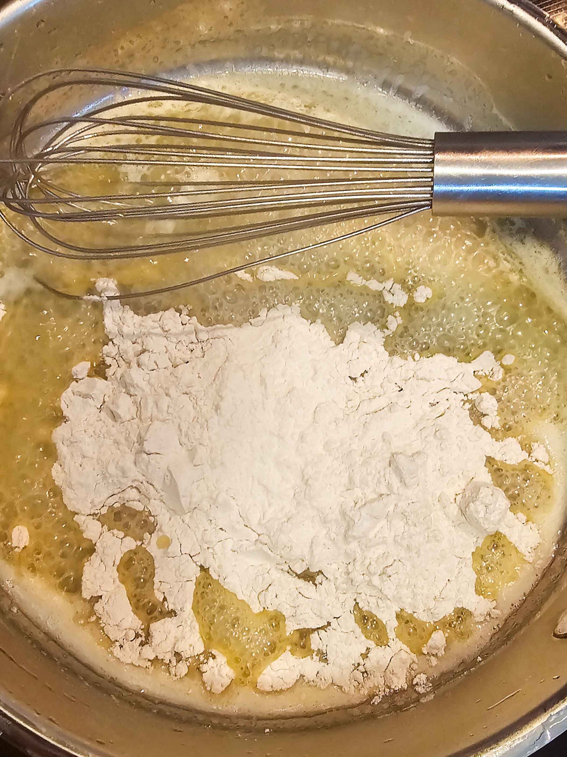 ADD THE FLOUR TO THE BUTTER AN BEGIN TO WHISK