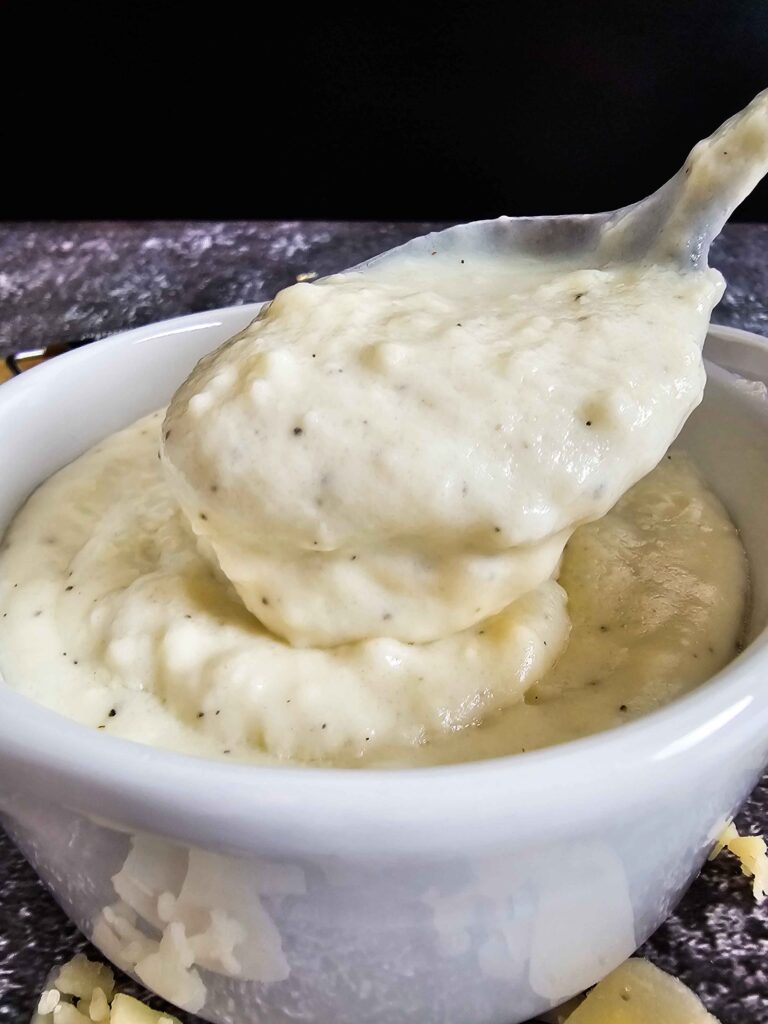 CREAMY SAUCE DRIPPING OFF THE SPOON TO SHOW THE THICKNESS AND CREAMINESS