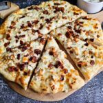 SET AS FEATURED IMAGE - SLICED PIZZA ON A WODDEN PIZZA BOARD