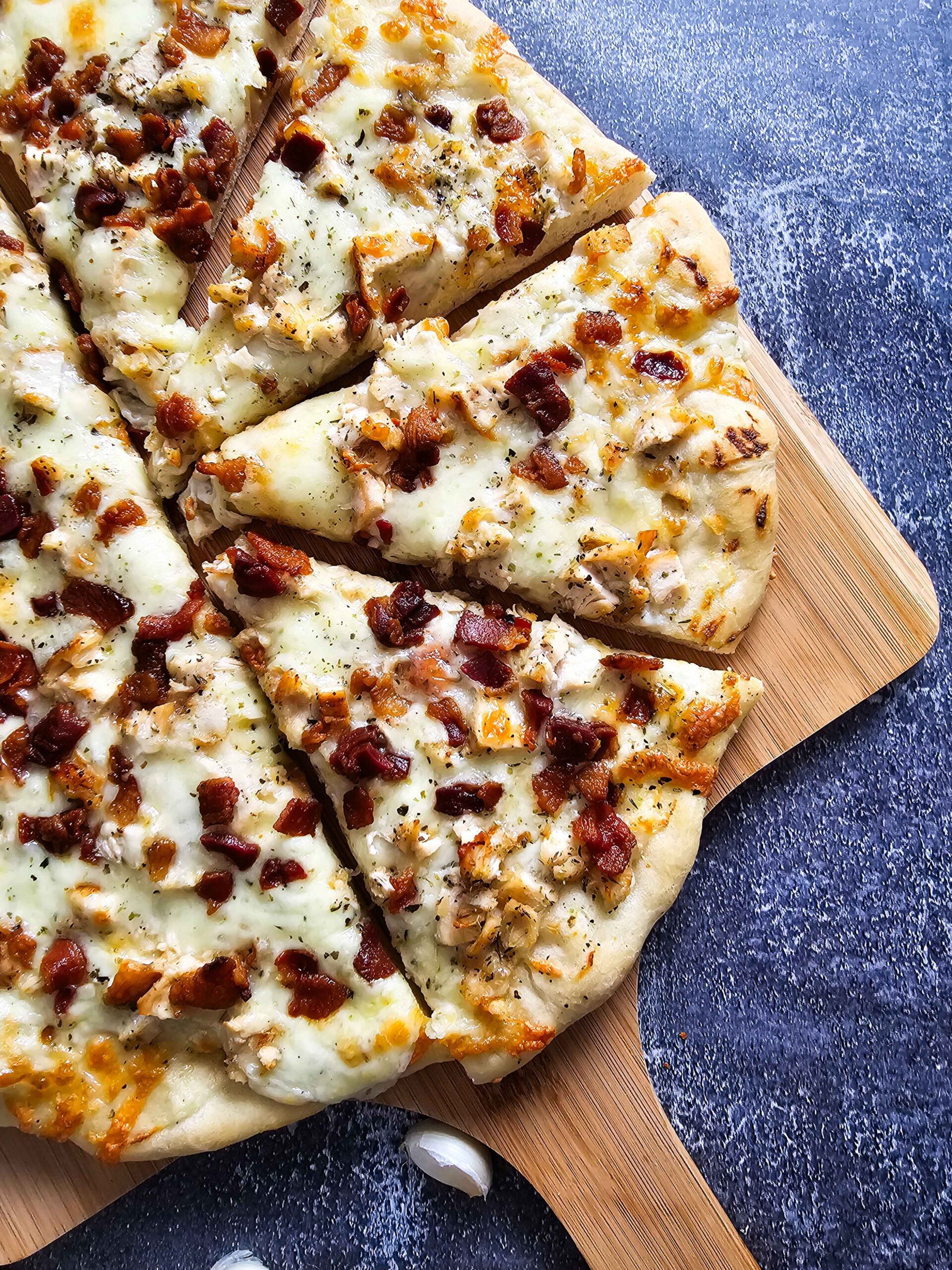 CHICKEN BACON WHITE SAUCE PIZZA SLICED UP FOR SERVING