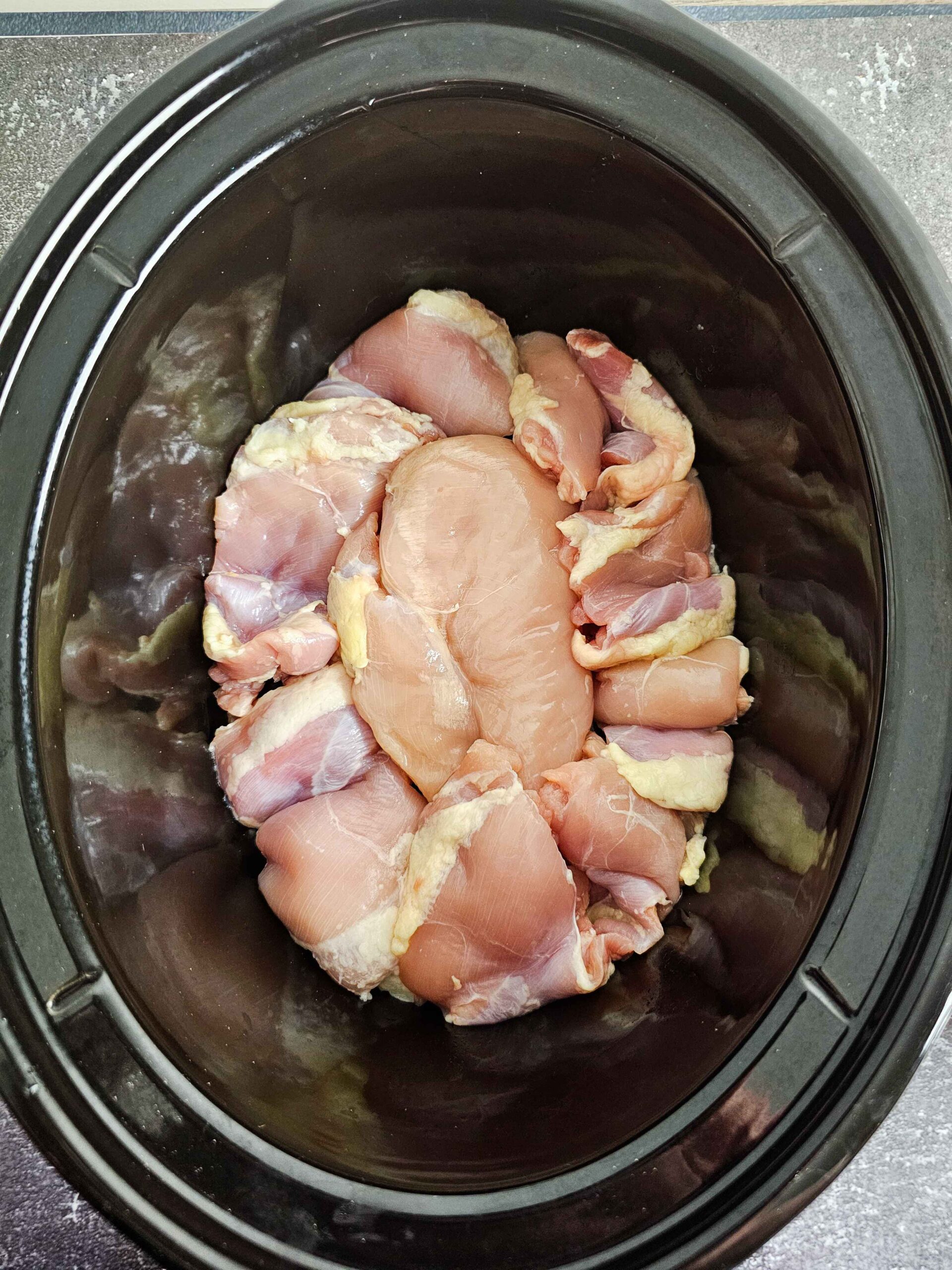 ARRANGE THE CHICKEN THIGHS ON THE BOTTOM OF THE CROCKPOT