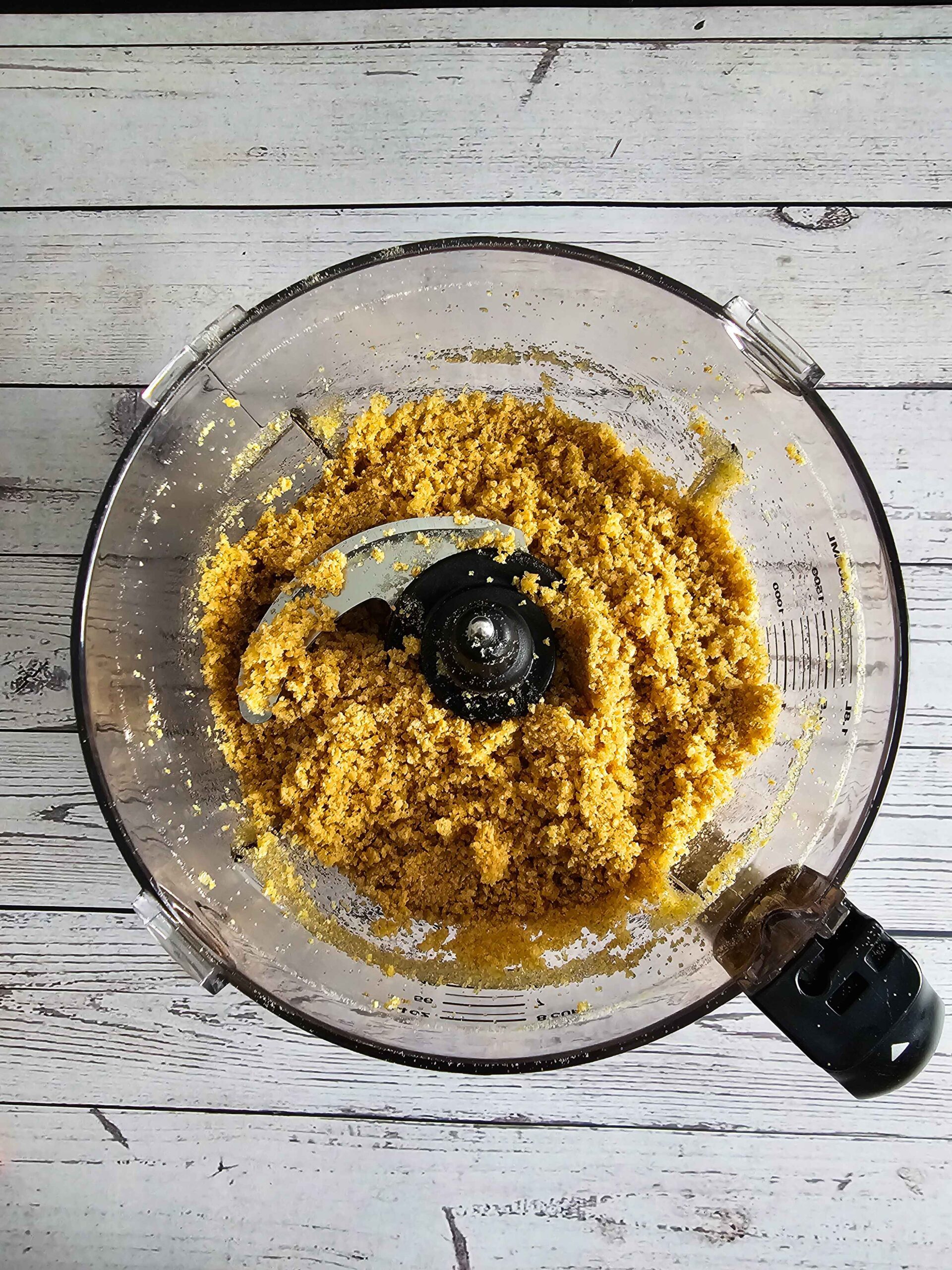 COMBINE THE BUTTER, SUGAR AND GRAHAM CRACKERS INTO FOOD PROCESSOR