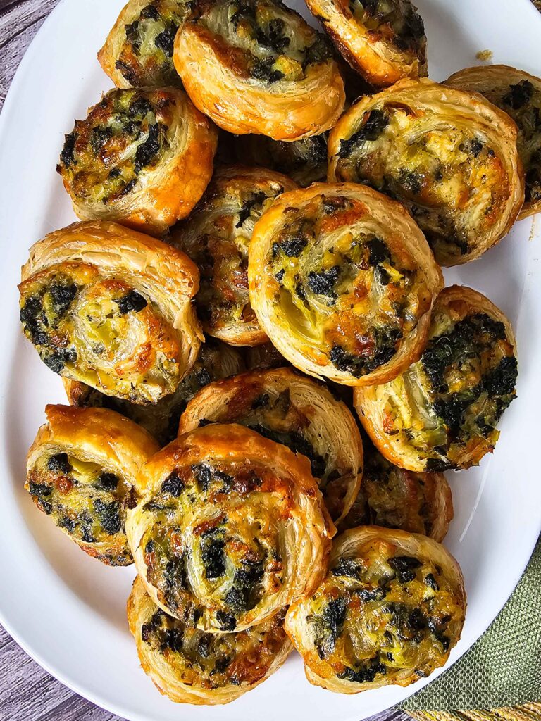 PLATE FULL OF SPINACH ARTICHOKE PUFF PASTERIES 