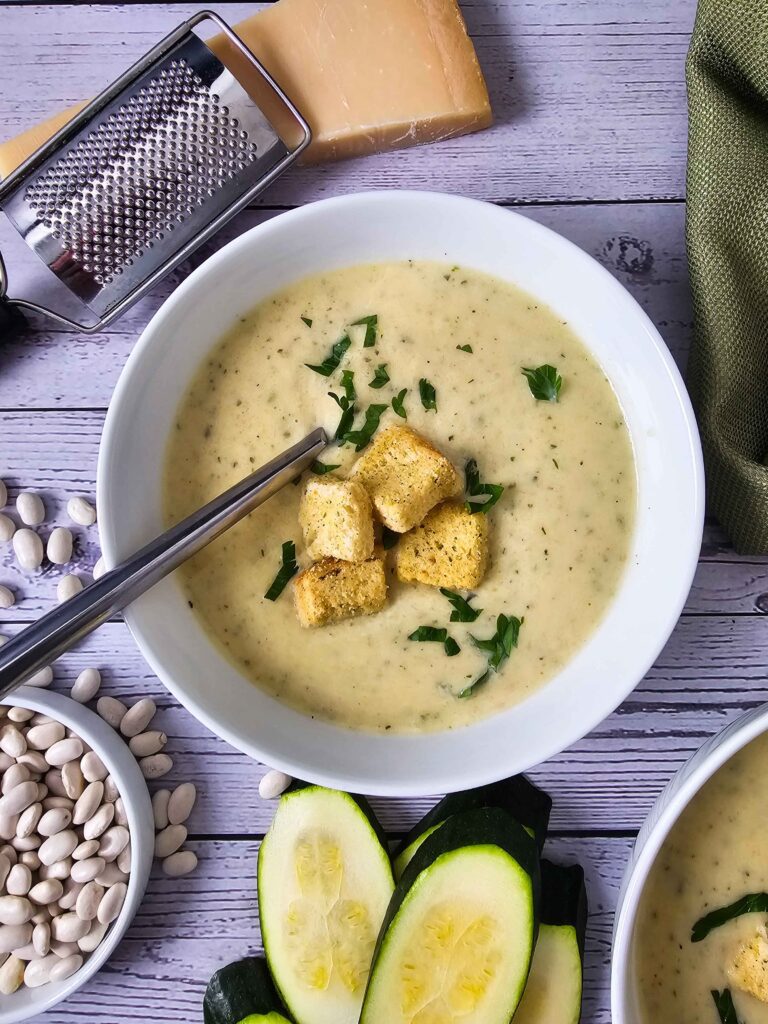 LARGE BOWL CREAMY ZUCCHINI SOUP GARNISHED WITH CROUTONS