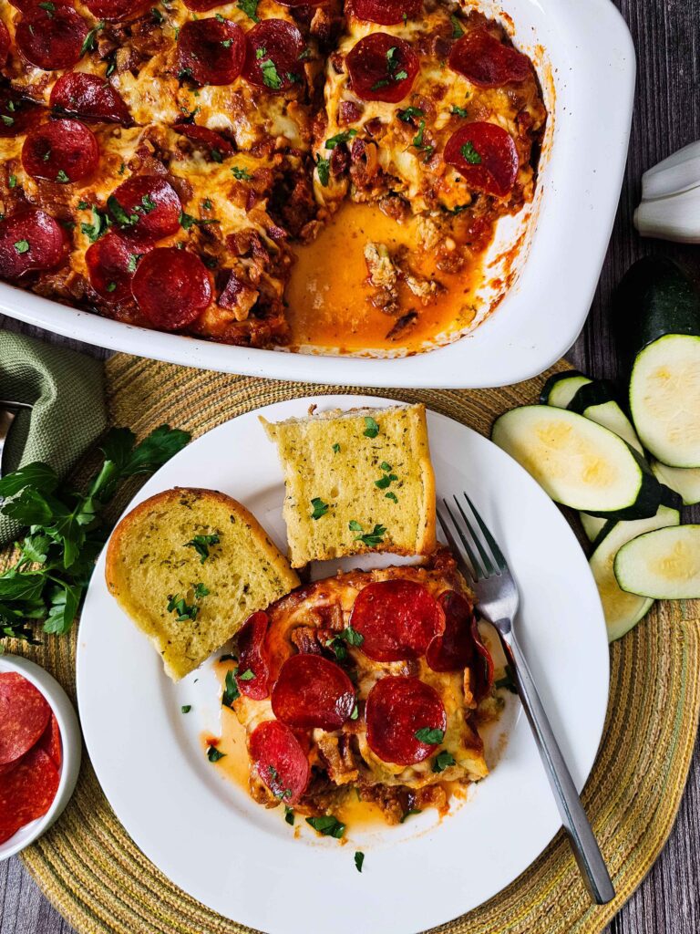 PLATED TRIPLE MEAT ZUCCHINI CASSEROLE WITH GARLIC BREAD