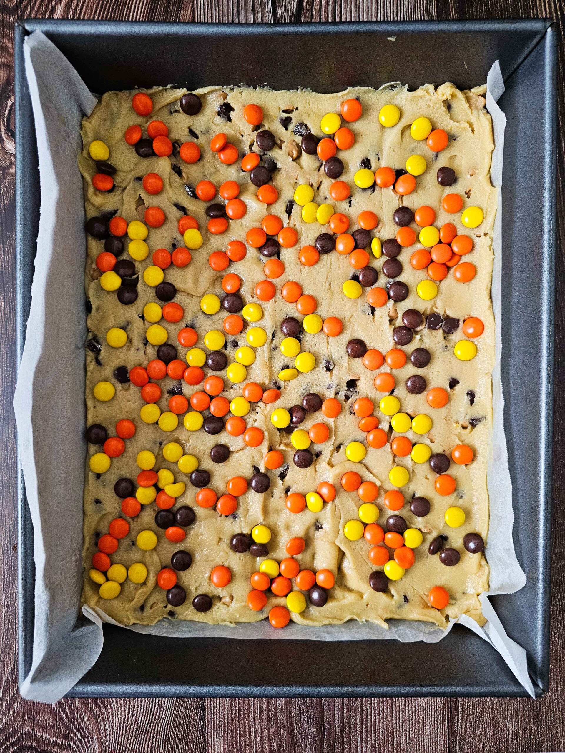 TOP THE COOKIE DOUGH WITH REESE'S PIECES