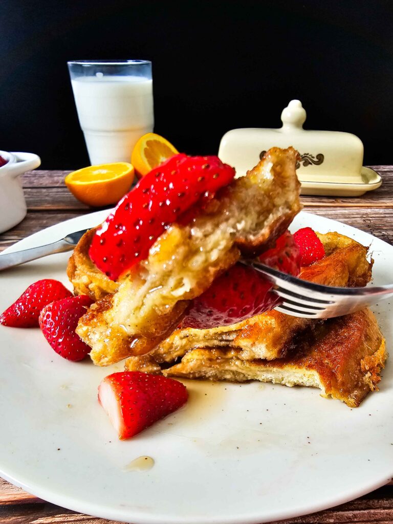 EGGY FRENCH TOAST ON THE FORK TO HIGHLIGHT THE TEXTURE