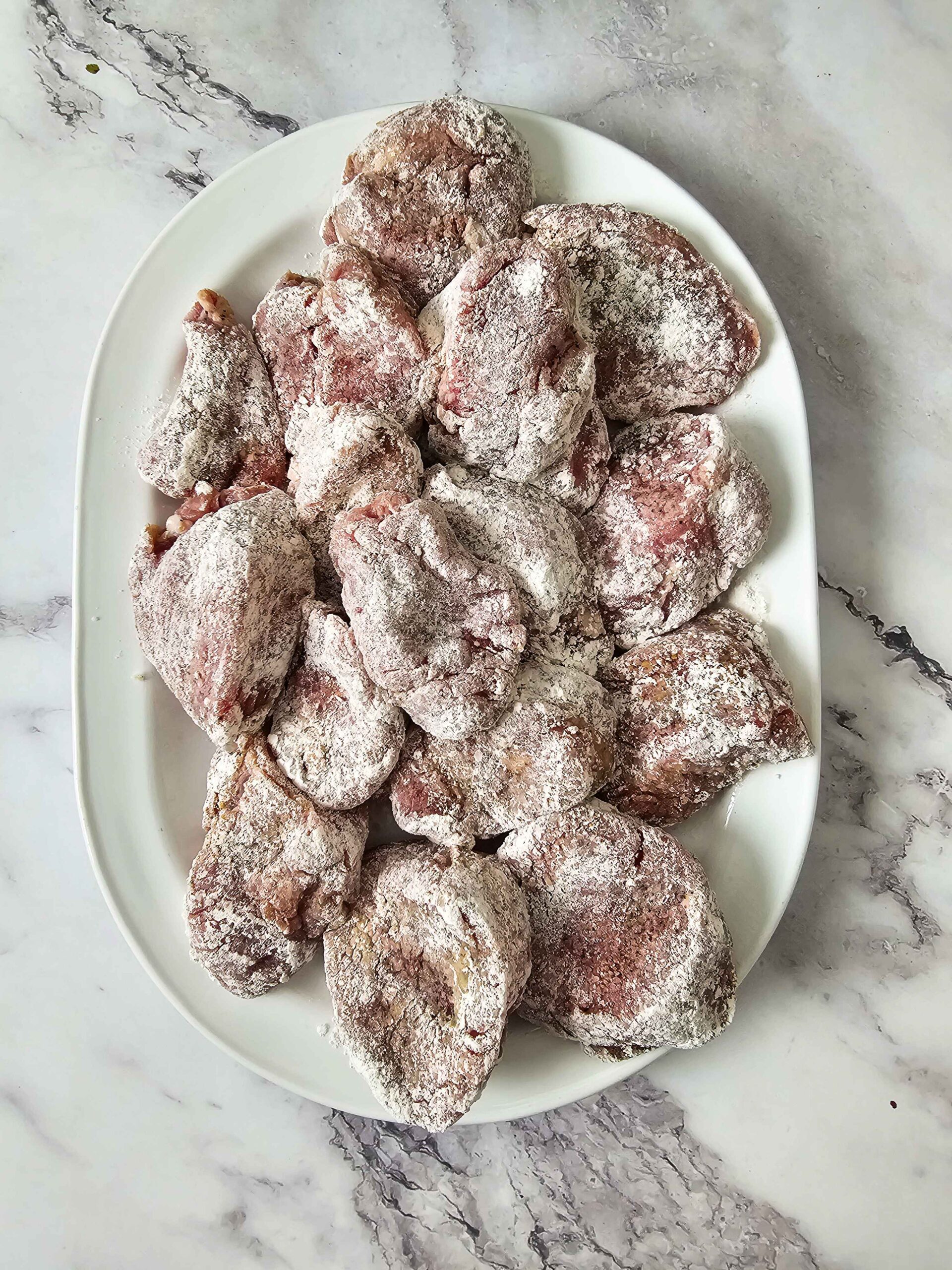 SLICE THE PORK INTO MEDALLIONS, SEASON AND DREDGE INTO FLOUR.