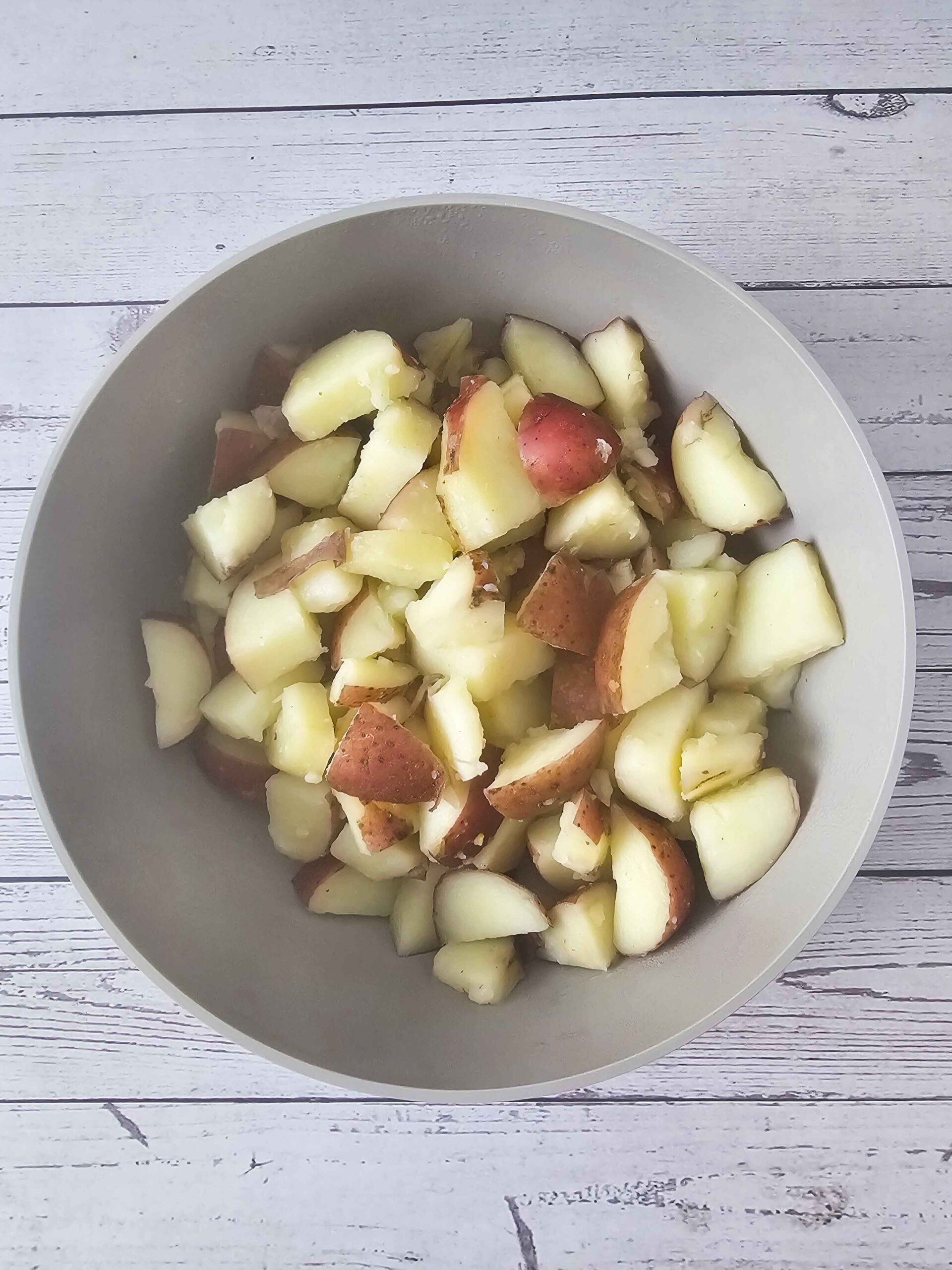 DRAIN THE TENDER BOILED RED POTATOES