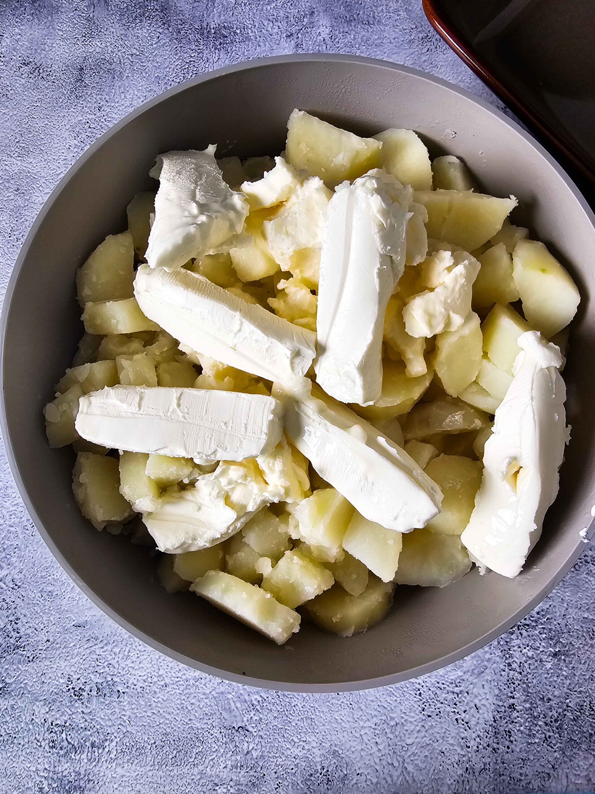 DRAIN AND ADD ALL THE INGREDIENTS AND MASH THE POTATOES