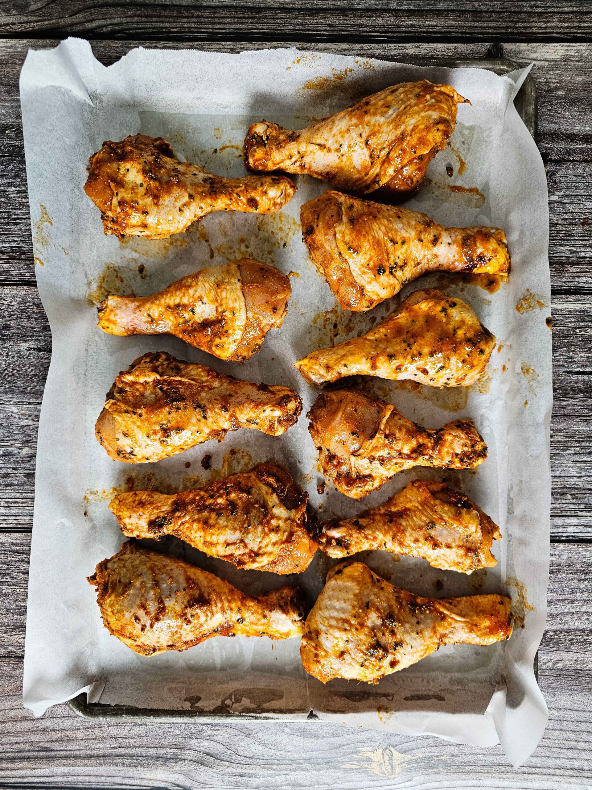 PLACE THE CHICKEN LEGS ON A BAKING SHEET LINED WITH PARCHMENT PAPER