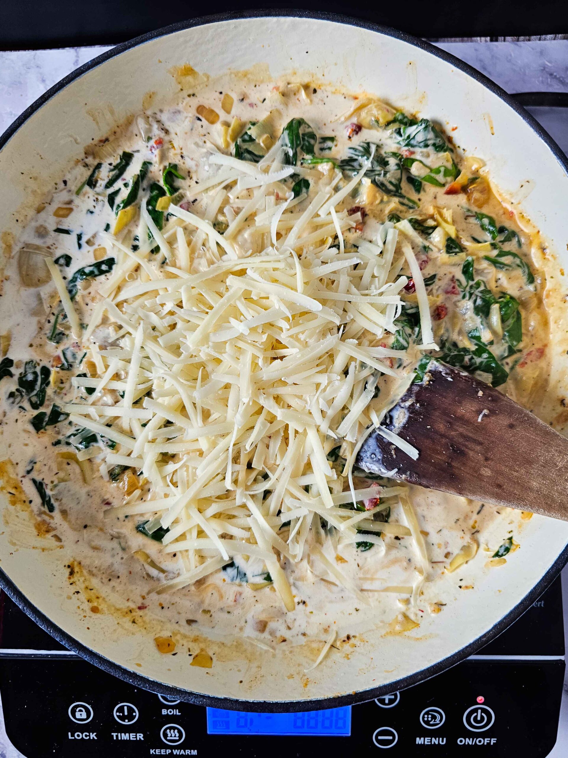 ADD THE PARMESAN CHEESE TO THE SKILLET