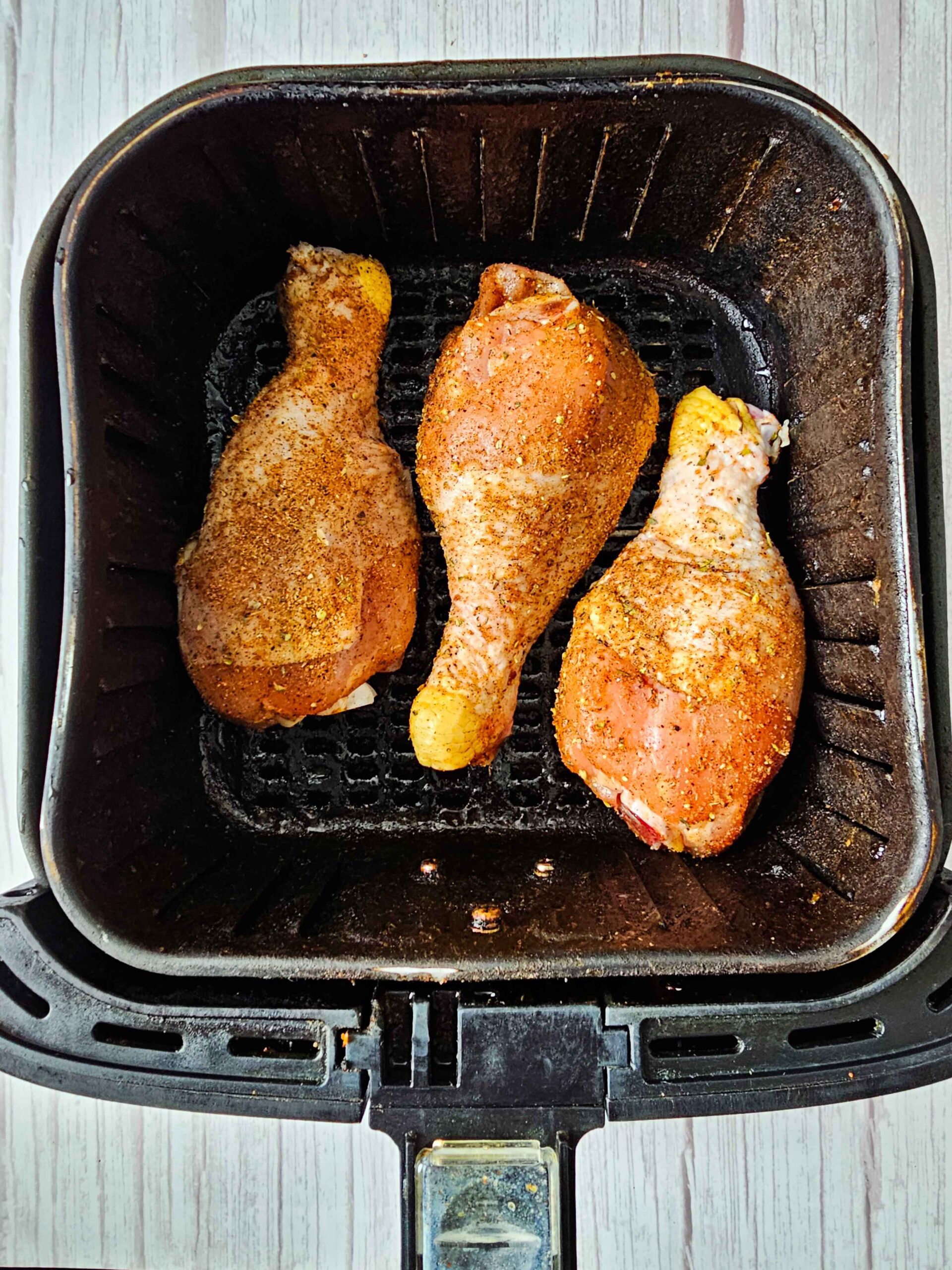 PREHEAT THE AIR FRYER 3 MINUTES AND ADD DRUMSTICKS TO THE FRY BASKET