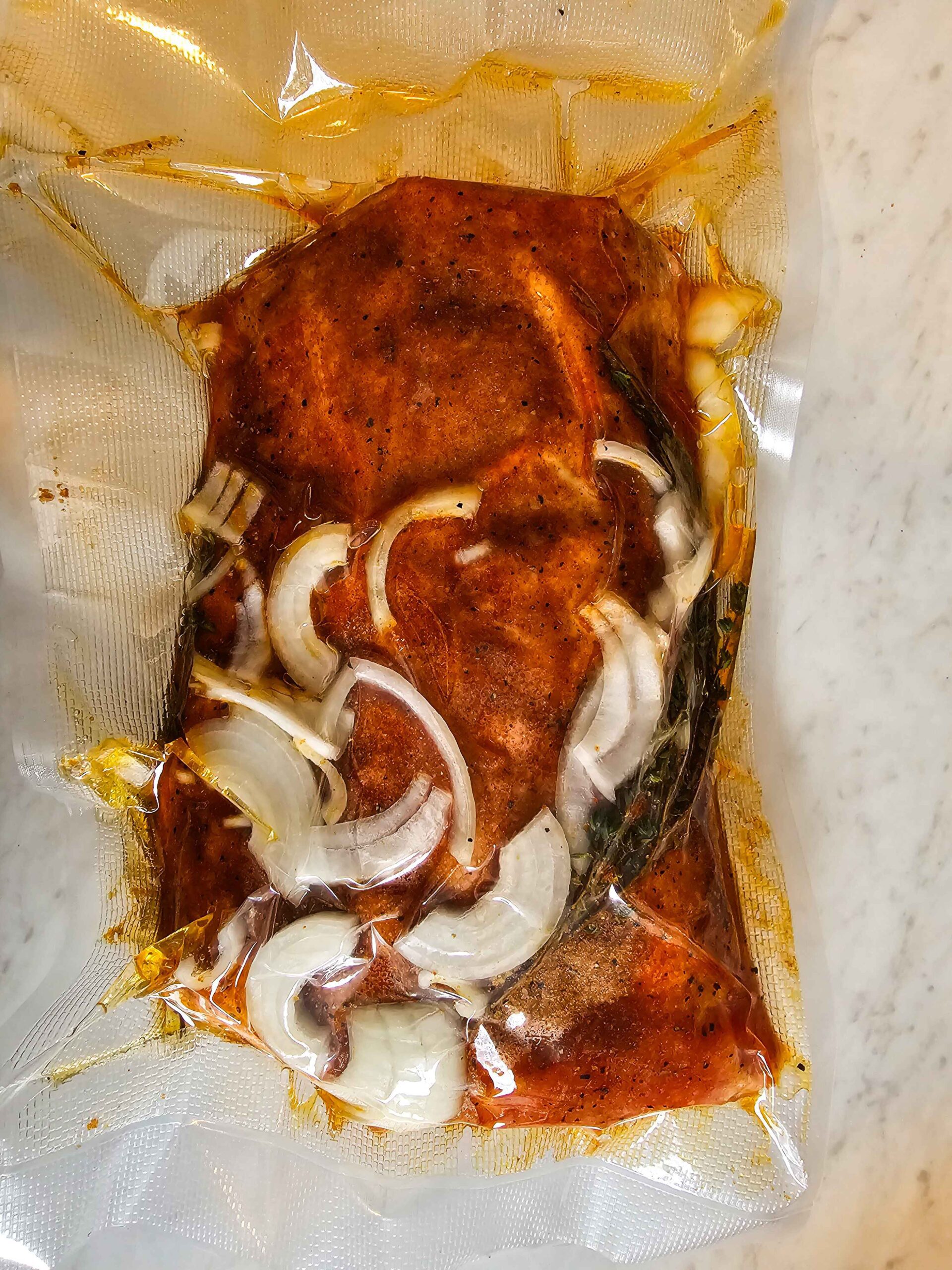 PLACE THE PORK LOIN ROAST INSIDE A VACCUUM SEALED BAG