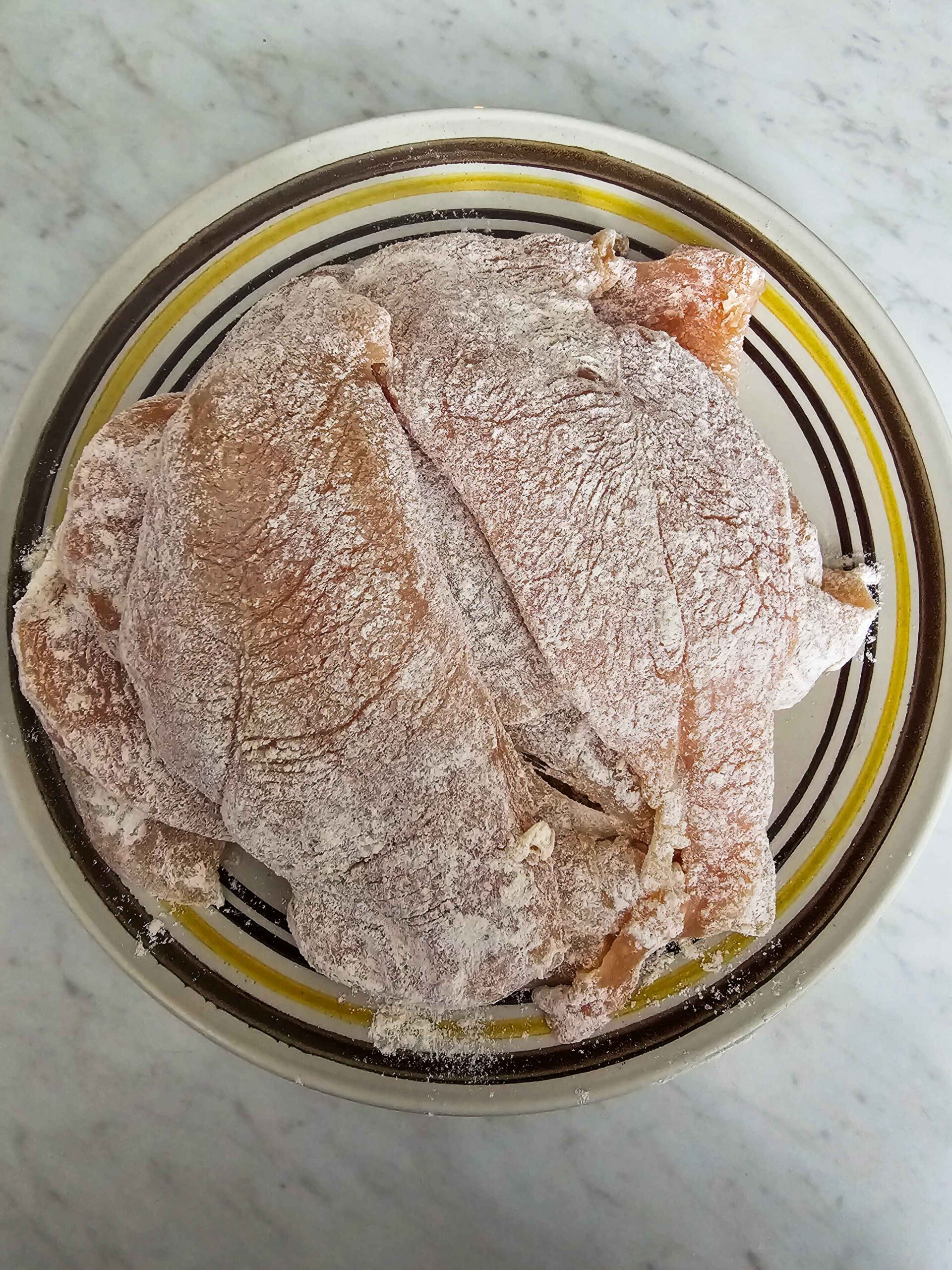 SEASON AND FLOUR THE CHICKEN BREASTS
