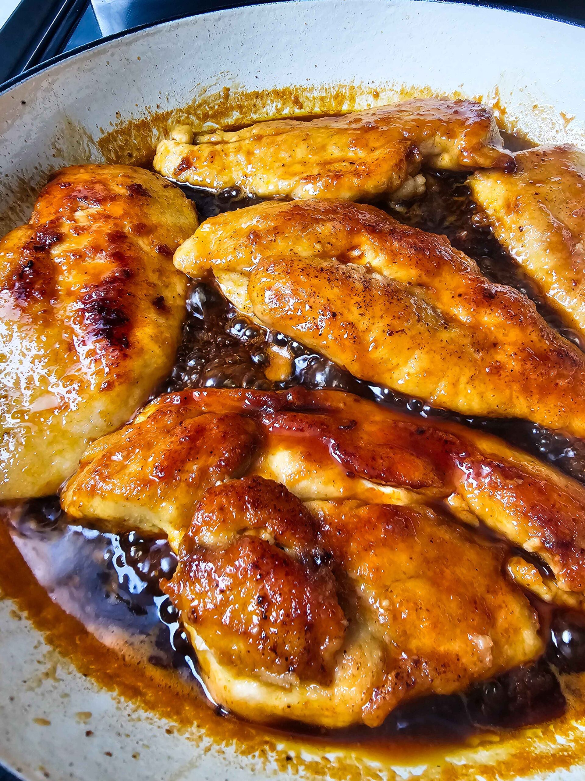 SIMMER THE SAUCE AND ADD THE CHICKEN BACK TO THE PAN TO WARM IT