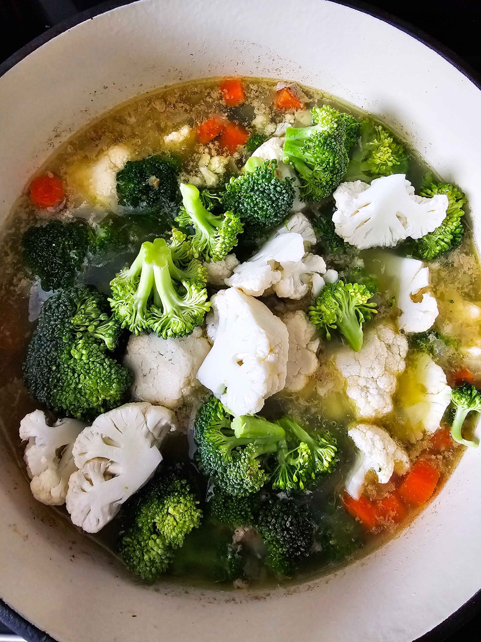ADD THE BROCCOLI AND CAULIFLOWER TO THE POT SIMMER ON LOW FOR 20 MINUTES UNTIL TENDER