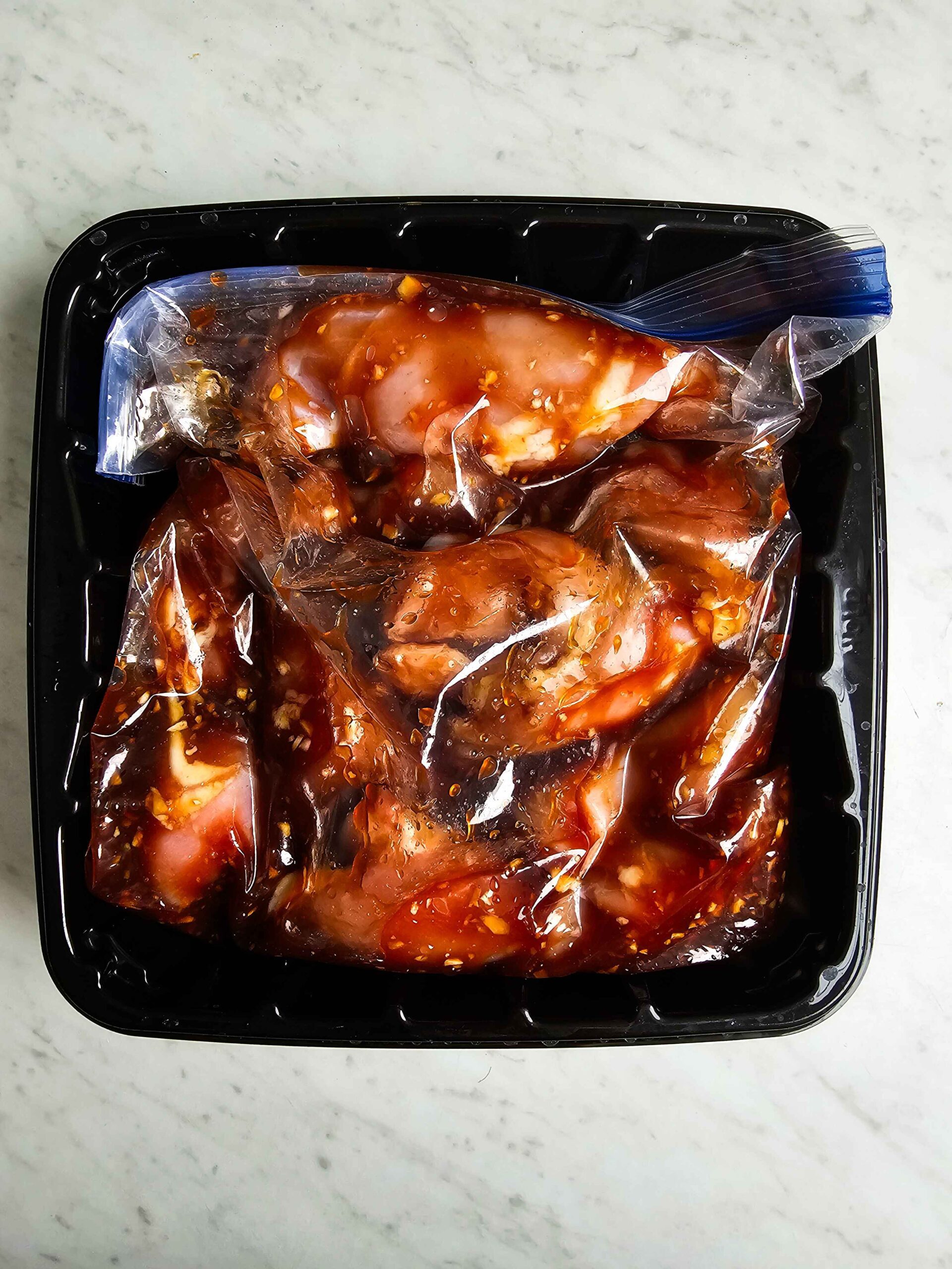 POUR THE MARINATE AND THE CHICKEN THIGHS INTO A ZIPTOP BAG